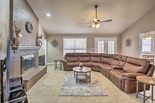 a living room with a couch and a fireplace at Large Yard Family-Friendly El Paso Rental Home in El Paso
