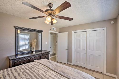 a bedroom with a ceiling fan and a mirror at Large Yard Family-Friendly El Paso Rental Home in El Paso