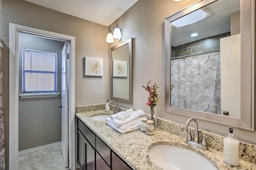 a bathroom with two sinks and a large mirror at Large Yard Family-Friendly El Paso Rental Home in El Paso