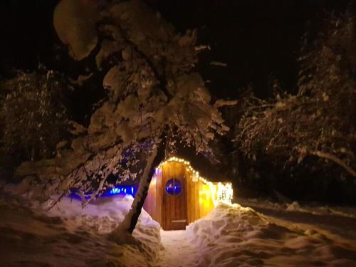 a house covered in snow at night with lights at Charming Chalet in Ventron with Terrace in Ventron