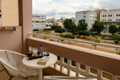 a balcony with a table and chairs and a view of a city at Bellevue Suites in Agios Nikolaos