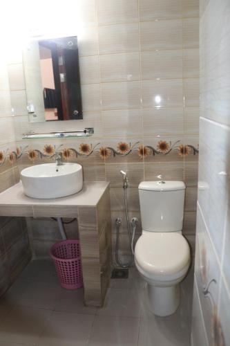 a bathroom with a toilet and a sink at The Blue Moon Hotel in Chittagong