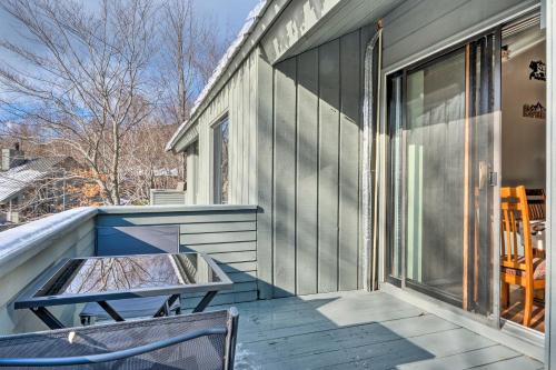 a balcony with a table and chairs on a house at Lincoln Escape with Deck 1 Mi to Loon Mountain! in Lincoln