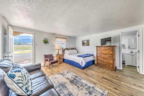 a living room with a bed and a couch at Convenient Tom Picketts Cabin with Mtn View! in Ruidoso Downs