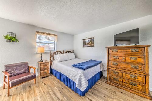 a bedroom with a bed and a dresser and a tv at Convenient Tom Picketts Cabin with Mtn View! in Ruidoso Downs
