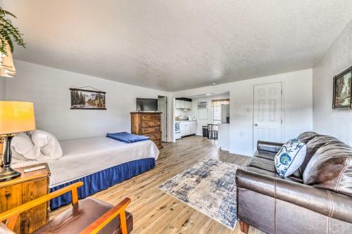 a living room with a bed and a couch at Convenient Tom Picketts Cabin with Mtn View! in Ruidoso Downs