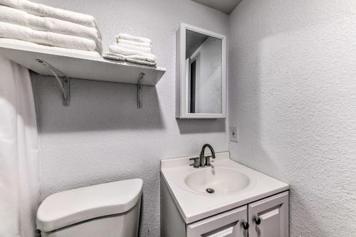 a bathroom with a white toilet and a sink at Convenient Tom Picketts Cabin with Mtn View! in Ruidoso Downs