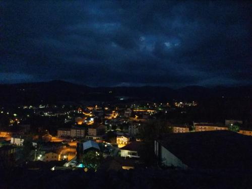 a view of a city at night at Hotel Centrale in Cascia