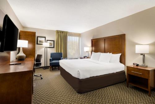 a hotel room with a bed and a television at Comfort Inn Lexington Virginia Horse Center in Lexington