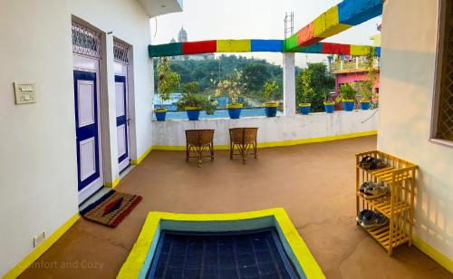 a view of a room with a balcony with a view at Comfort and Cozy in Orchha