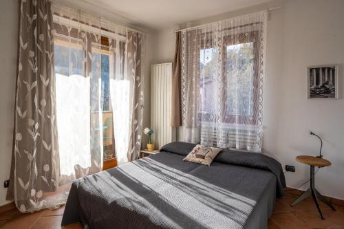 a bedroom with a bed and a large window at Casa Furia in Ponte della Venturina