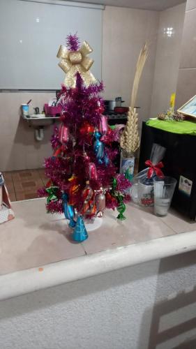 un árbol de Navidad púrpura sentado en la parte superior de una mesa en Boutique Hilda, 