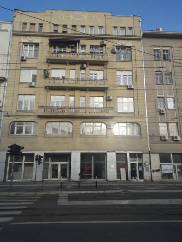 a tall building with a balcony on top of it at Jasmin in Belgrade