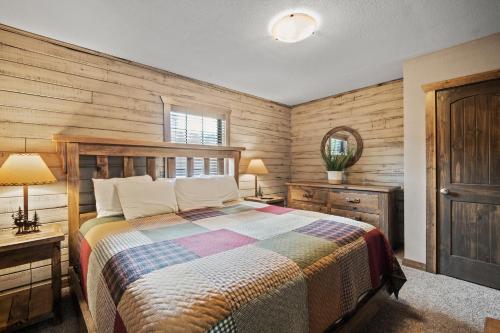 a bedroom with a bed and a wooden wall at Table Rock Resorts at Indian Point in Branson