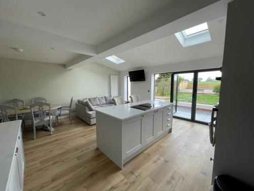 a kitchen and living room with a couch and a table at Newly renovated 3 Bed property - countryside views in Dunstall