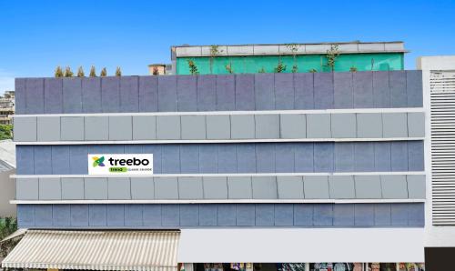 un edificio con una señal de Tico en el costado en Treebo Trend Classic Grande, Camp en Pune