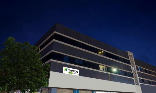 a black building with a sign in front of it at Treebo Classic Grande, Camp in Pune