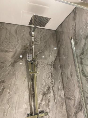 a shower in a bathroom with a stone wall at Unicorn in Selby