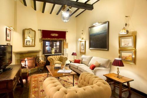 a living room with couches and a fireplace at Parador de Santillana Gil Blas in Santillana del Mar