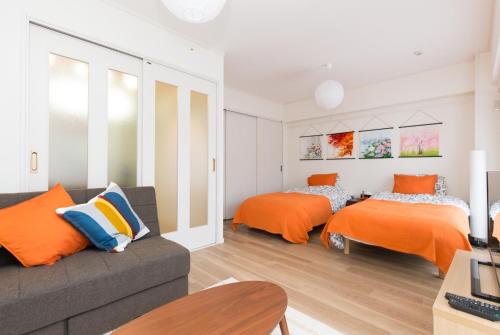 a living room with two beds and a couch at Amber Iidabashi - Vacation STAY 90436v in Tokyo