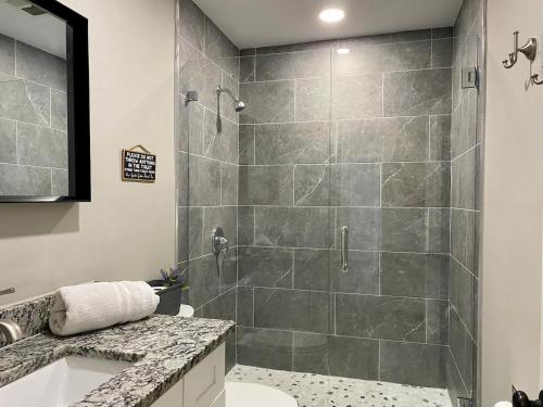 a bathroom with a shower and a toilet and a sink at Spacious 5 bedrooms 3 bathrooms Family-Friendly Home With Heated salt Pool in Clearwater