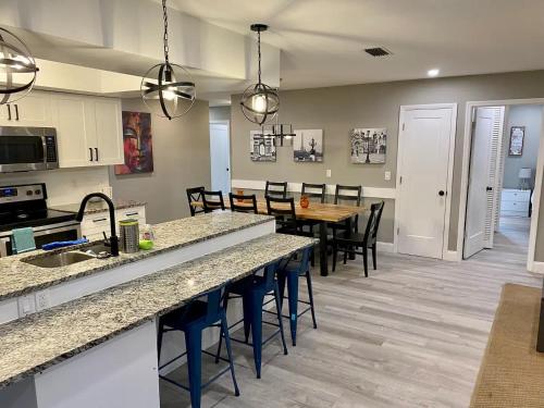 a kitchen and dining room with a table and chairs at Spacious 5 bedrooms 3 bathrooms Family-Friendly Home With Heated salt Pool in Clearwater