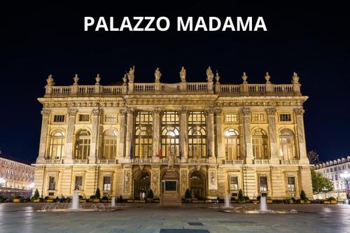 a large building is lit up at night at Appartamenti Vista Mole, Centro a 15 min - Luxury Suites & fast WiFi in Turin