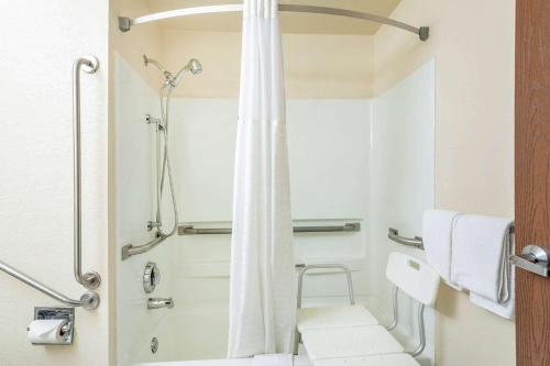 a bathroom with a shower with a shower curtain at Super 8 by Wyndham Cheyenne WY in Cheyenne