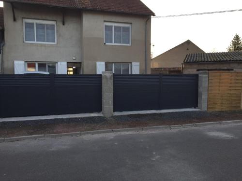 a black fence in front of a house at Logement, idéal famille, amis, tout y est ! in Dompierre-sur-Besbre