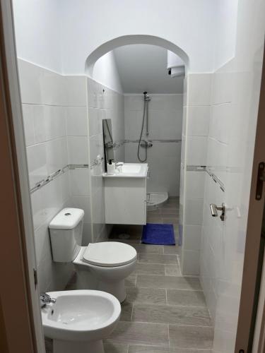 a white bathroom with a toilet and a sink at Casa Paraiso Tenerife in Los Abrigos