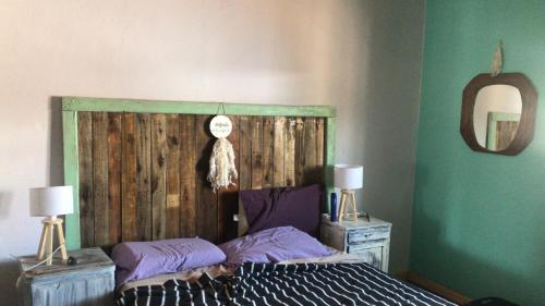 1 dormitorio con 1 cama con cabecero de madera en Los Chañares en San Carlos