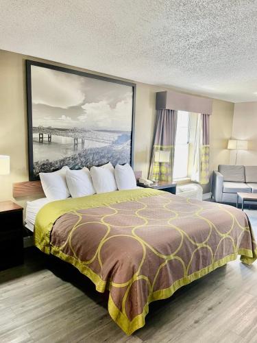 a hotel room with a bed and a view of a pier at Super 8 by Wyndham Bay St. Louis in Bay Saint Louis