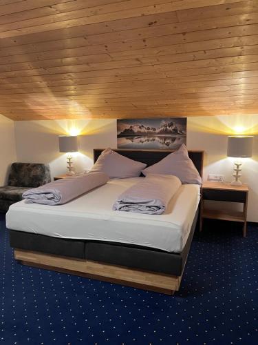 a bedroom with a large bed with a wooden ceiling at Appartement Bichl in Sölden