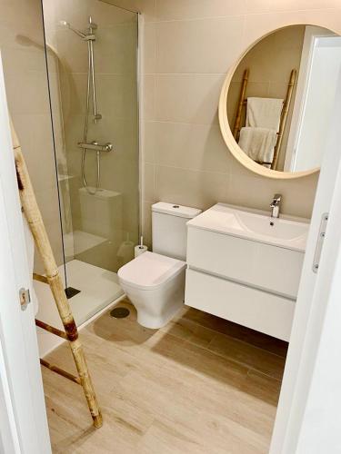 a bathroom with a toilet and a sink and a mirror at Marina Real 82 by homeprive in Denia
