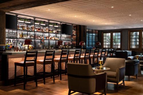a bar in a restaurant with chairs and a bar counter at Omni La Mansion del Rio in San Antonio