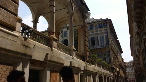 a group of people standing on a balcony of a building at L'Americano Luxury Rooms in Chiavari