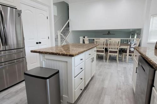 a kitchen with white cabinets and a counter top at 5 bedroom house to share with your family and friends in Provo