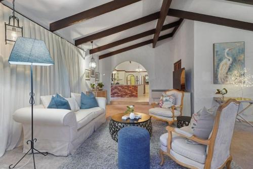 a living room with a white couch and chairs at Magnificent Beachfront Mansion - Pool - Fireplace in Auckland