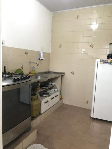 cocina con fogones y nevera blanca en Hostel Selaron en Río de Janeiro