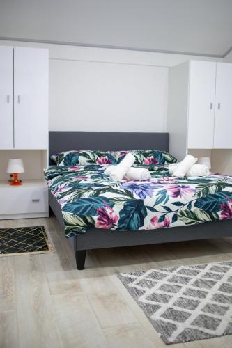 a bedroom with a bed with a floral bedspread at Villa Spa Heaven in Novska