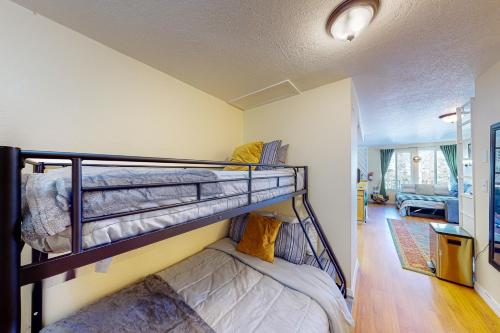 a bedroom with two bunk beds and a living room at Timberbrook B210 in Brian Head