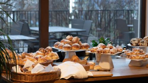 a table with several plates of pastries and bread at Nad Strumykiem in Jabłonna Majątek