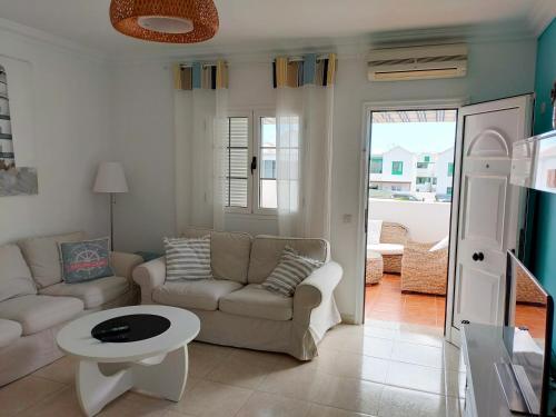 a living room with a couch and a table at Apartment Luz De Faro in Playa Honda