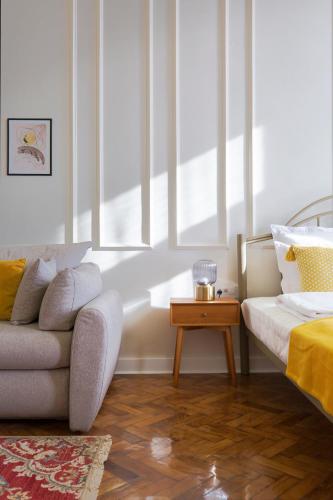 a living room with a couch and a table at The Gate rooms in Novi Sad