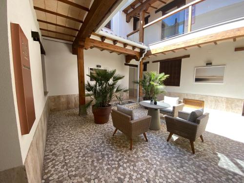 a patio with chairs and a table in a building at IBSEN Almagro in Almagro