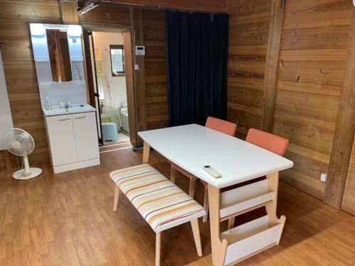 a room with a table and two chairs and a bathroom at Kura "Ika" - Vacation STAY 95263v in Nagahama