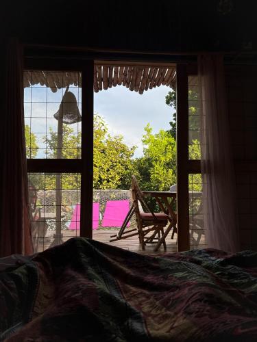 a bedroom with a window looking out at a patio at Laguna Rosa Glamping in Coveñas