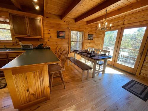 a kitchen with a table and chairs in a cabin at The Mountaineer Cabin Walk to Greenway 5min to ASU in Boone