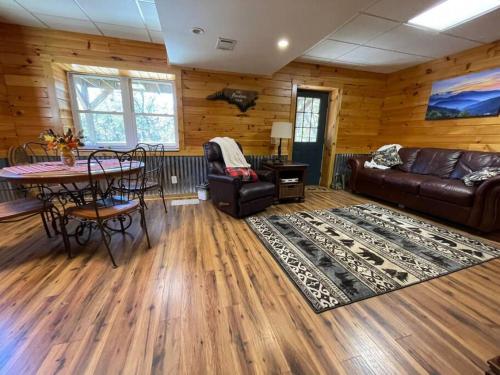 a living room with a couch and a table at The Mountaineer Cabin Walk to Greenway 5min to ASU in Boone