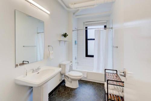 a white bathroom with a sink and a toilet at Historic Place in Downtown in Memphis